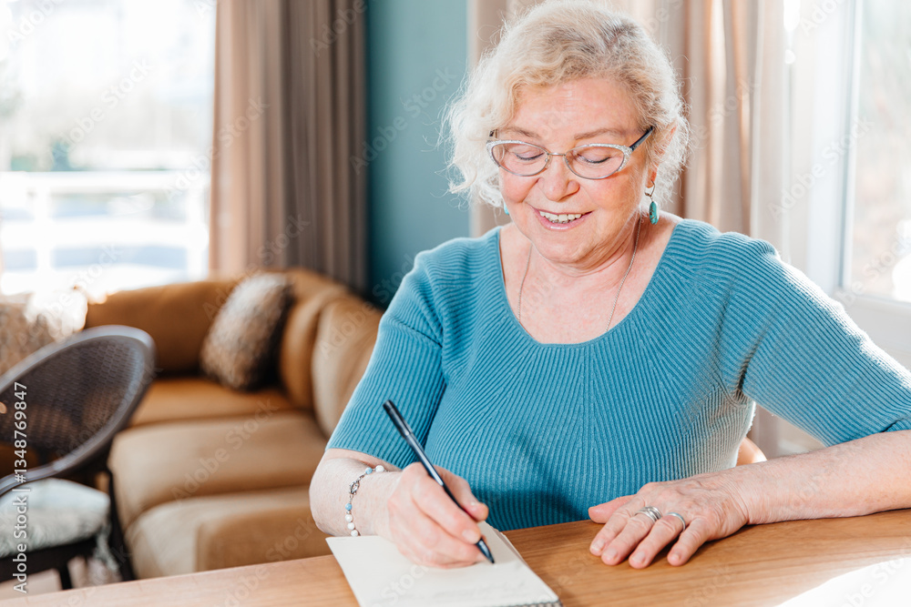 Smiling Elderly Woman Writing in a Notebook at Home Smiling Elderly Woman Writing in a Notebook at Home