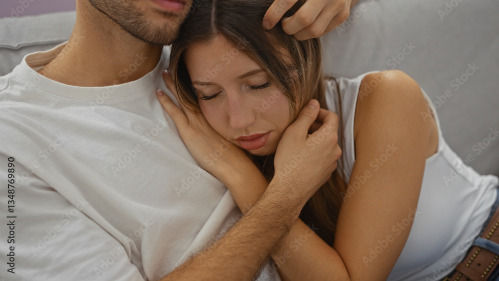 Couple cuddling lovingly on a couch in an intimate living room setting, showcasing tenderness and affection between a man and a woman at home. Couple cuddling lovingly on a couch in an intimate living room setting, showcasing tenderness and affection between a man and a woman at home.