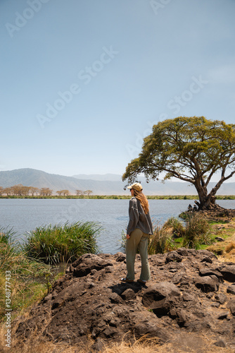 Tourist observing lake magadi in ngorongoro conservation area, tanzania