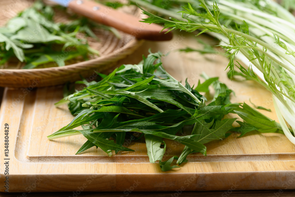 Mizuna, Water green, Japanese mustard green or spider mustard on cutting wooden board Mizuna, Water green, Japanese mustard green or spider mustard on cutting wooden board