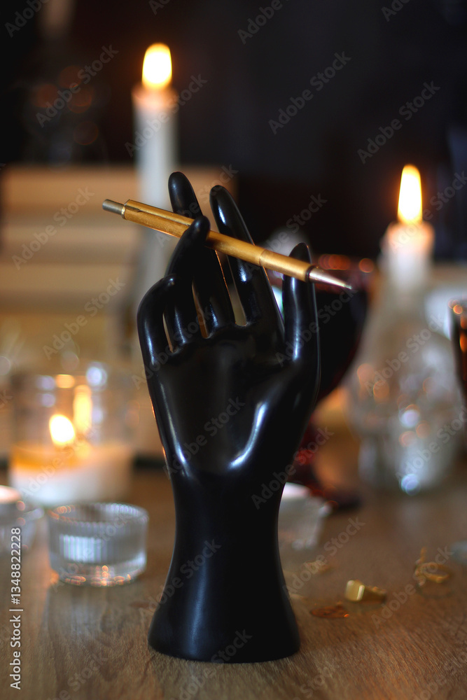 Books, lit candles, red wine, snacks and various deocration on the table. Dark academia or Halloween concept. Selective focus.