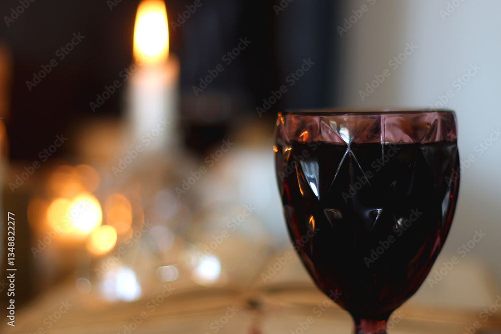 Books, lit candles, red wine, snacks and various deocration on the table. Dark academia or Halloween concept. Selective focus.