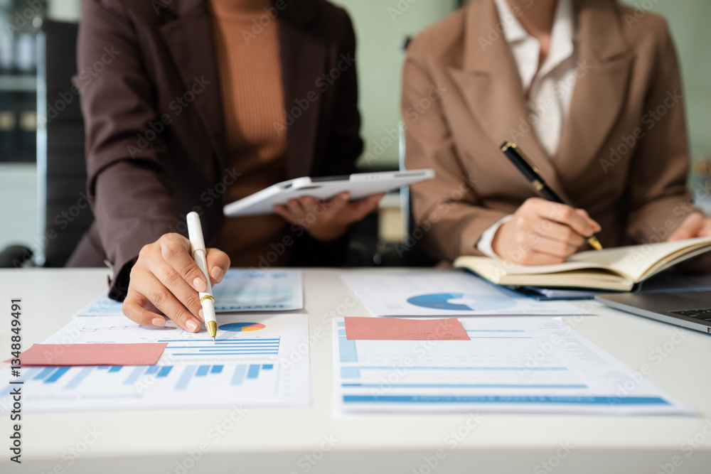 Businessmen team or financial data analysts working with tablets and laptop computers and data graphs together. Plan to analyzing projects in the office.. Businessmen team or financial data analysts working with tablets and laptop computers and data graphs together. Plan to analyzing projects in the office..
