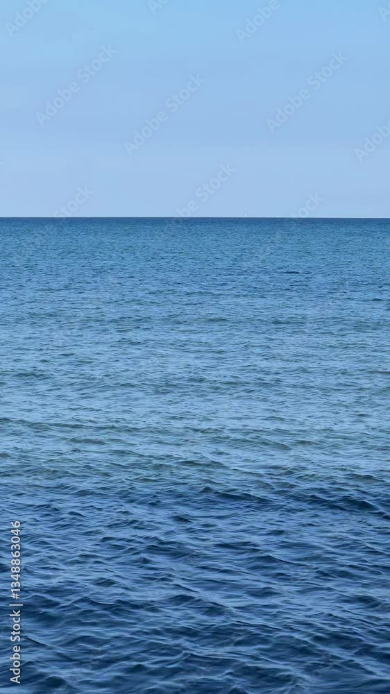 Panorama of the deep blue, calm Mediterranean Sea in Larnaca, Cyprus. A perfect concept of serene waters and a summer vacation in Europe Panorama of the deep blue, calm Mediterranean Sea in Larnaca, Cyprus. A perfect concept of serene waters and a summer vacation in Europe