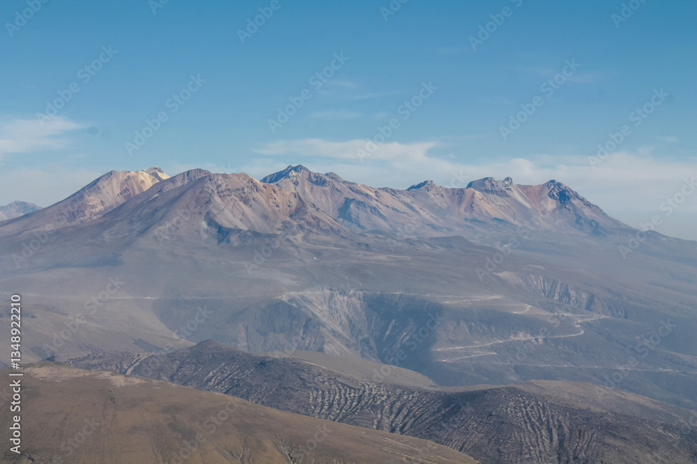 Naklejka premium Volcanic desert landscape of Andes mountains in South America. High mountain summit in the middle of desert high altitude altiplano, volcano El Misti crater near Arequipa city in Peru. Volcanic land