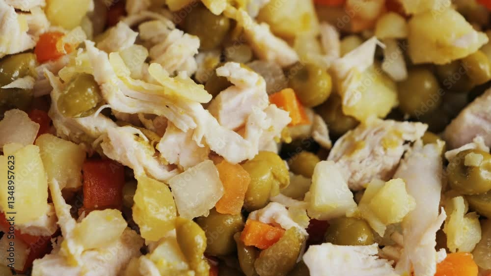 Salad with beef, potatoes and boiled vegetables and canned peas dressing creamy sauce. Classic Olivier salad. . High quality 4k footage