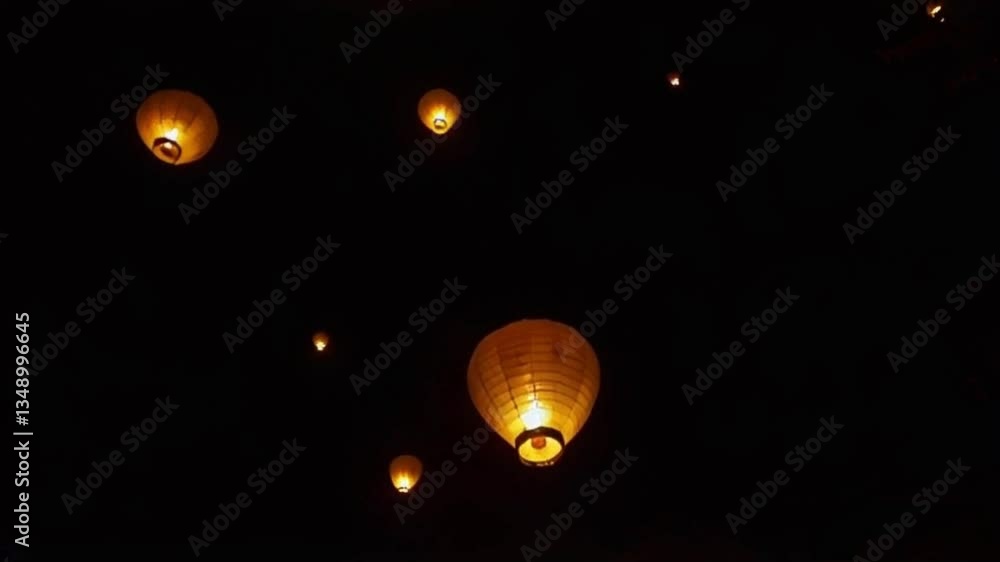 Peaceful Scene of Glowing Lanterns Rising Into the Dark Night Sky, Lanterns Warm Light Flickering Peaceful Scene of Glowing Lanterns Rising Into the Dark Night Sky, Lanterns Warm Light Flickering