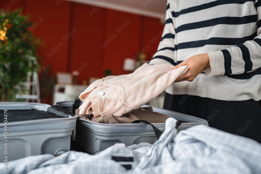Fototapeta premium Packing Clothes into a Suitcase for a Trip or Travel