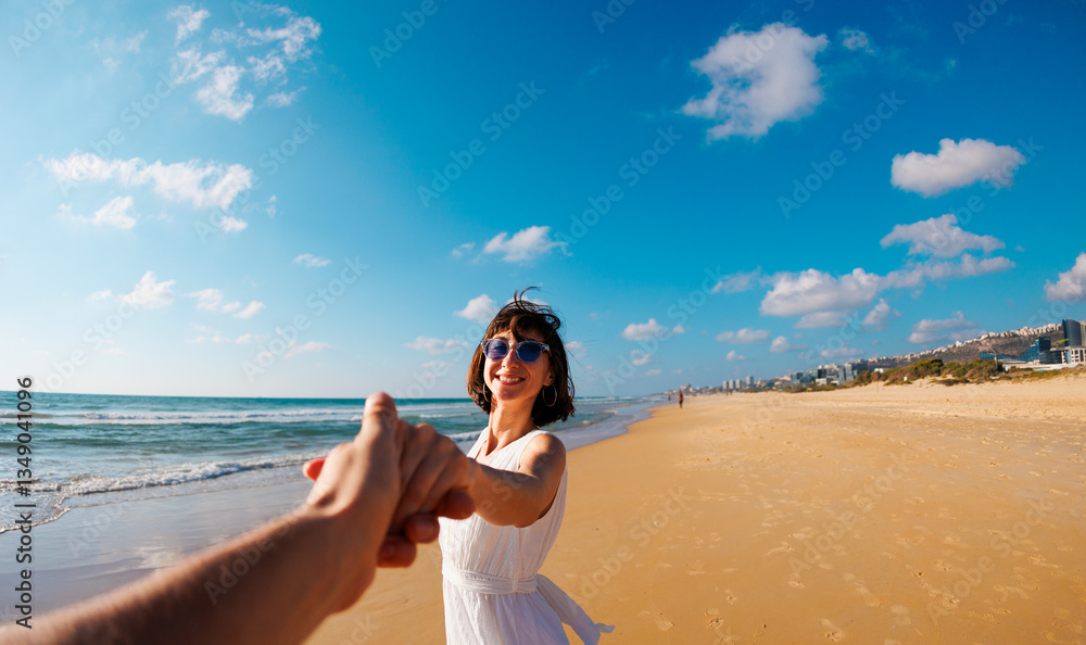 couple in love having fun on the beach. Follow me. couple in love having fun on the beach. Follow me.