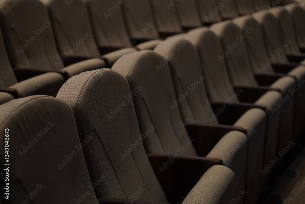 Fototapeta premium Chairs upholstered in gray beige textiles in the concert hall