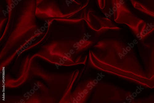 The top view of the red satin surface looks luxurious and beautiful. with sparkling waves Abstract background design copy space Card or banner (blurred or blurry)