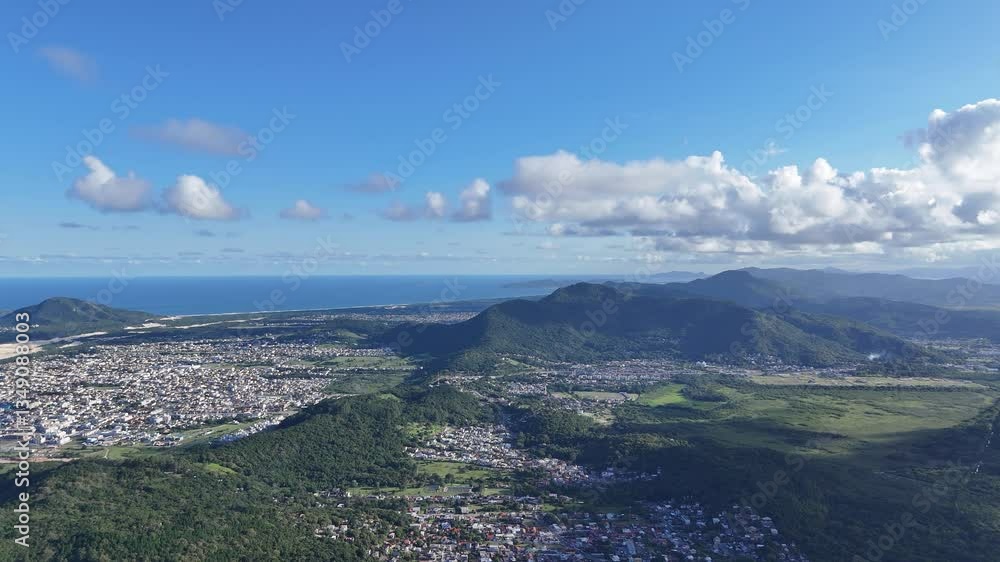 Scenic view of coastal town and mountains during clear daylight hours Scenic view of coastal town and mountains during clear daylight hours
