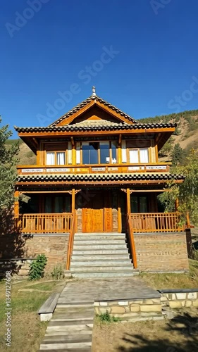 Wallpaper Mural Beautiful wooden chalet surrounded by nature with clear blue sky in a mountainous area, showcasing traditional architectural design and warm colors Torontodigital.ca