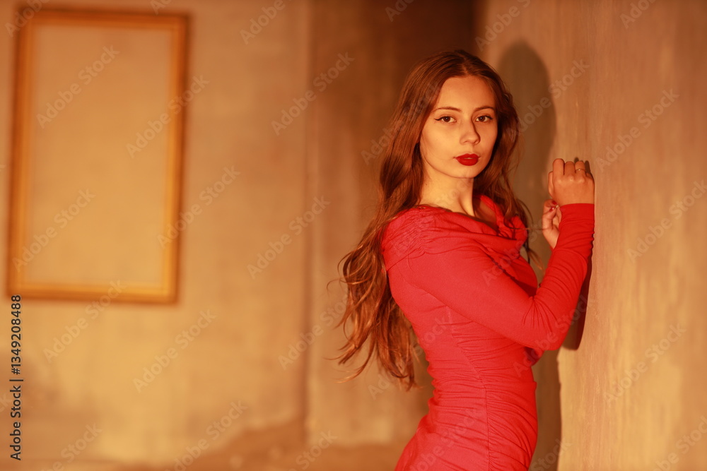 Fototapeta premium Studio portrait of young brunette woman in red dress