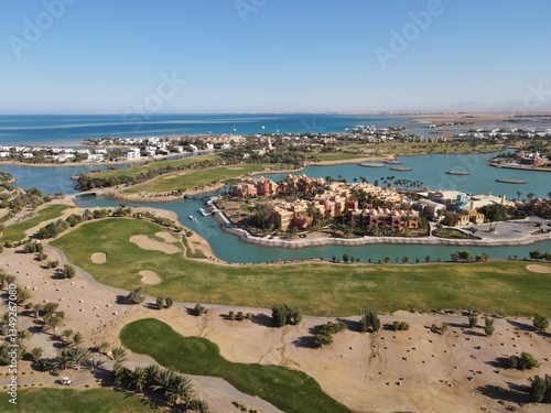 Beautiful drone overview of big golf course with lakes by tourists town El Gouna in The Red Sea, Egypt