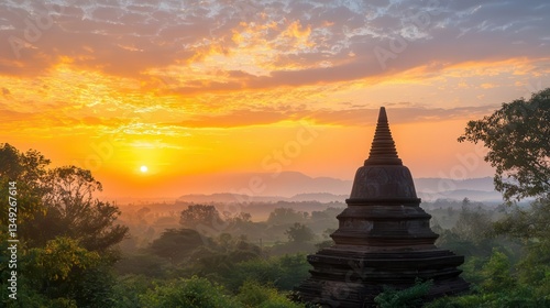 Sunset over an ancient pagoda surrounded by trees, warm golden light illuminating the structure and sky