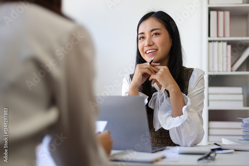 Wallpaper Mural Female employee is talking with a colleague in the office. Asian woman doing job interview in office. Torontodigital.ca