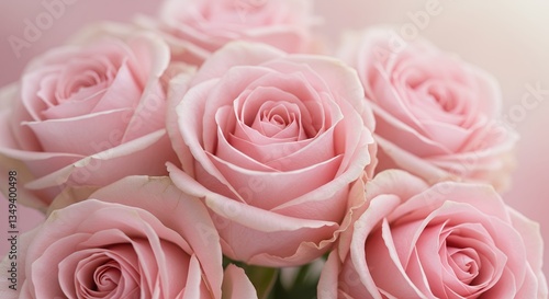 Soft light highlighting delicate pink roses in a romantic arrangement