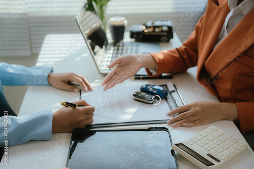 The salesperson meets with the new owner after signing the sales contract. This transaction includes financing, insurance, and legal documents to ensure a smooth and safe car sale or lease process.