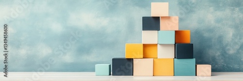Colorful blocks arranged in ascending order against a blue background.  Growth and stability concept