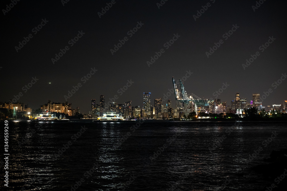 City skyline illuminated at night with boats on the water reflecting vibrant lights in a bustling urban environment City skyline illuminated at night with boats on the water reflecting vibrant lights in a bustling urban environment