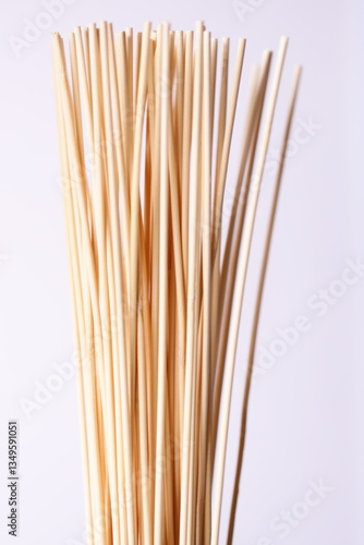 Wallpaper Mural A collection of bamboo sticks arranged neatly on a white background, suitable for use in design or photography projects. Torontodigital.ca