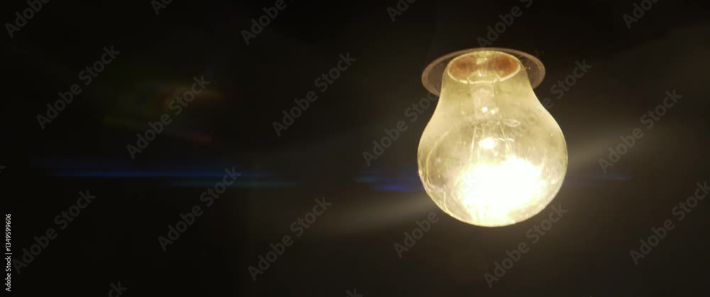 Old light bulb filament glows in the dark 4K slomo scope video Old light bulb filament glows in the dark 4K slomo scope video