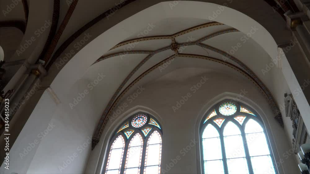 The vaulted ceiling of Riga Cathedral displays Gothic ribbed arches with decorative tracery, paired with pointed stained-glass windows, reflecting medieval craftsmanship. The vaulted ceiling of Riga Cathedral displays Gothic ribbed arches with decorative tracery, paired with pointed stained-glass windows, reflecting medieval craftsmanship.