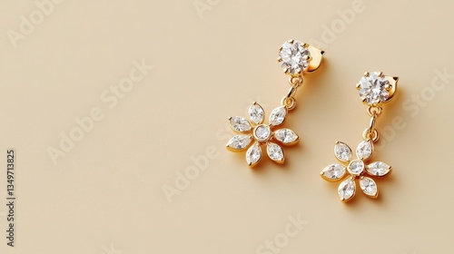 Chandelier earrings with sparkling floral motifs and diamonds, isolated on a smooth beige surface