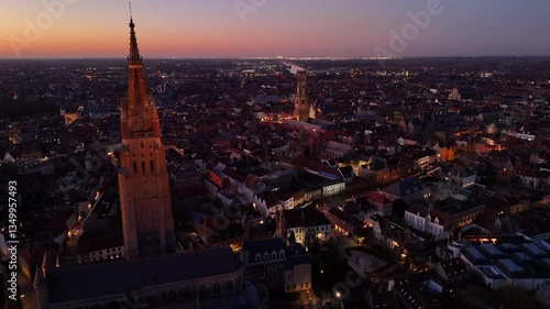 Bird's eye view of Brugge, Belgium showcasing historic architecture and vibrant sunset skyline