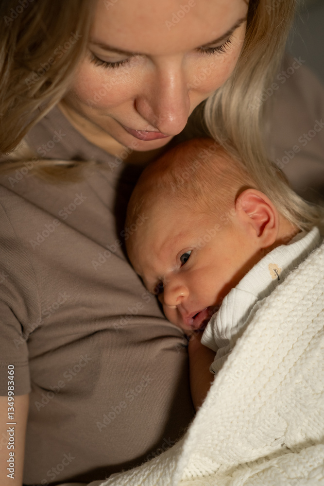 Mother lovingly embraces her newborn baby during a quiet moment at home, capturing the bond of love and care in a peaceful setting Mother lovingly embraces her newborn baby during a quiet moment at home, capturing the bond of love and care in a peaceful setting