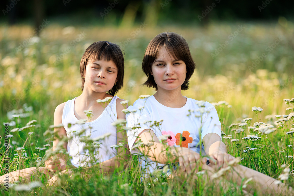 Portrait of sisters spending time together in park in summer