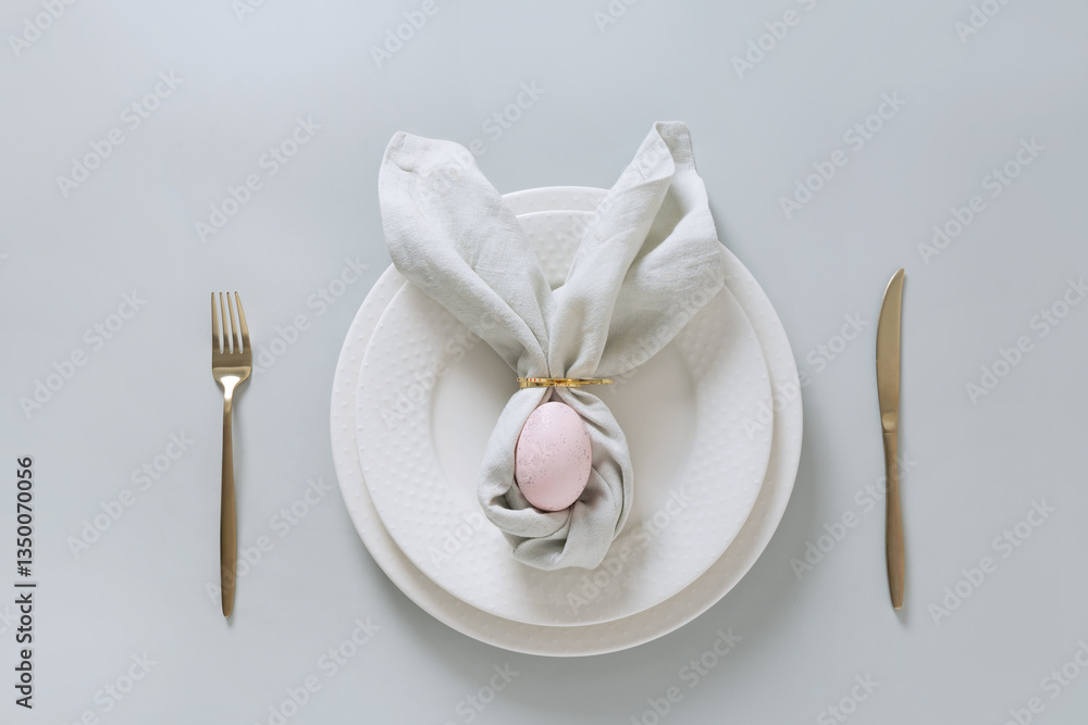 Easter spring table setting with pink egg on gray background. Happy creative Easter decoration. View from above.