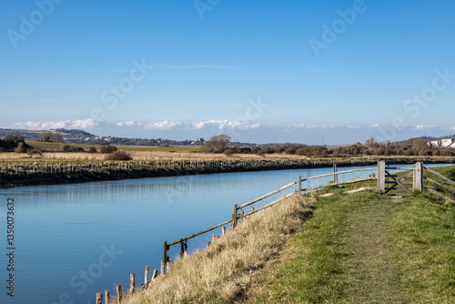 Wallpaper Mural A grass pathway along the River Ouse between Lewes and Southease, with a blue sky overhead Torontodigital.ca