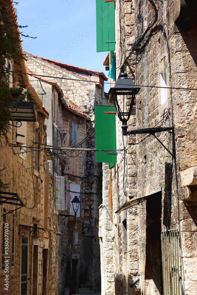 Picturesque Mediterranean street and traditional architectural details in Trogir, Croatia.