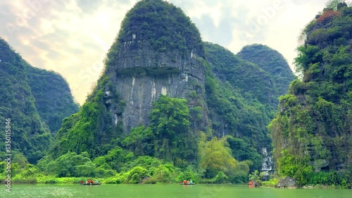 Trang An River Ninh Minh and Bai Dinh Mountain ranges in Vietnam only 3 hours drive from Hanoi. Beautiful winding river and large rising mountains. boats going through the caves in the river