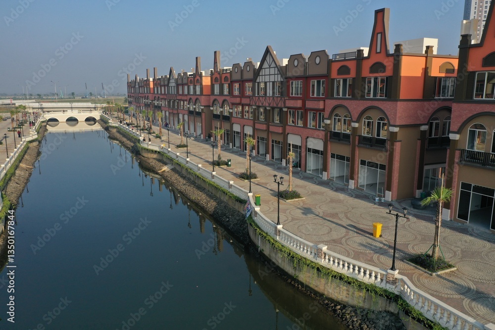 Fototapeta premium Aerial view of the shophouse area in the Pantai Indah Kapuk (PIK) area which is similar to Amsterdam, Netherlands