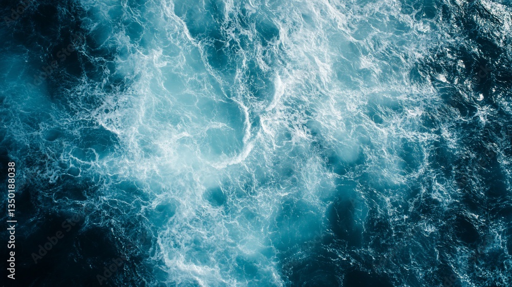 Aerial view of churning ocean water with white foam and shades of blue Aerial view of churning ocean water with white foam and shades of blue