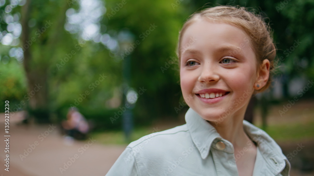 Small kid strolling park looking distance portrait. Lovely funny child walking
