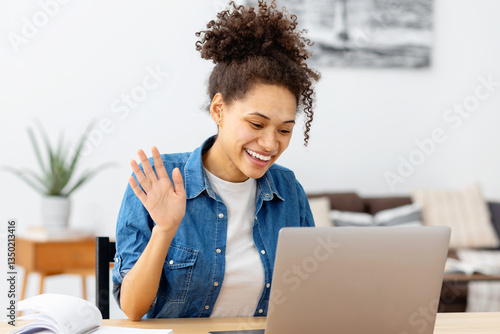 Happy young woman having video call at home