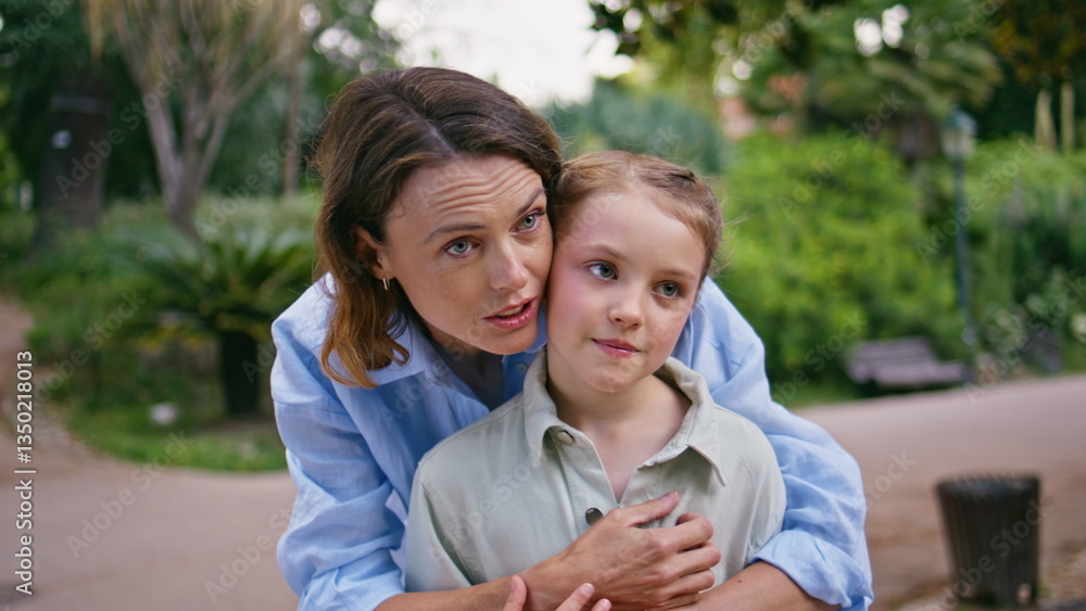 Tender mother daughter cuddling in park resting together closeup. Loving moment Tender mother daughter cuddling in park resting together closeup. Loving moment