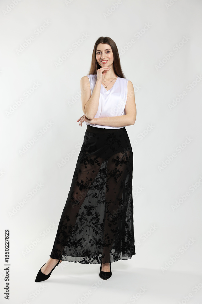 Fototapeta premium Beautiful woman in stylish outfit on white background