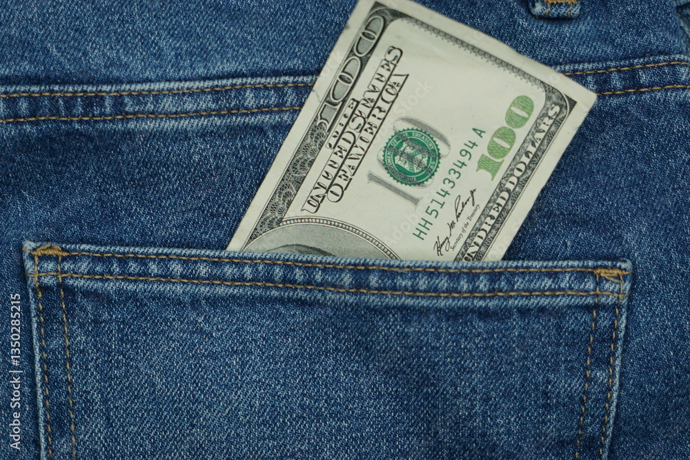 One hundred dollars in a back pocket of blue jeans One hundred dollars in a back pocket of blue jeans