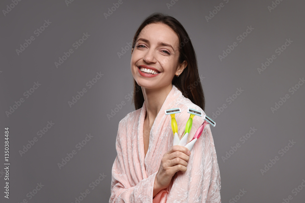 Happy woman with different razors on grey background. Hair removal tools Happy woman with different razors on grey background. Hair removal tools
