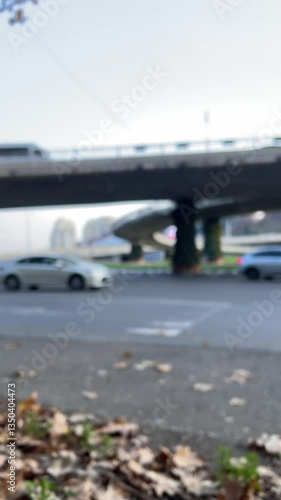 Wallpaper Mural Vertical 4K city video. Car flow out of focus on street near bridge on Heroes Square in Tbilisi. Blurred background. Concept of traffic jam, speed, travel, driving, road trip, way. Copy space. Day Torontodigital.ca