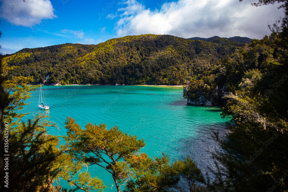 Naklejka premium panorama of Stilwell Bay in Abel Tasman National Park. Little paradise beaches with turquoise water surrounded with tropical vegetation. Famous great walk in New Zealand South Island