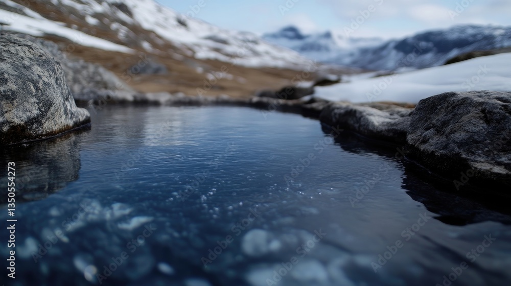 Obraz premium Mountain spring reflecting snowy peaks. Clear, tranquil water nestled within rocky terrain