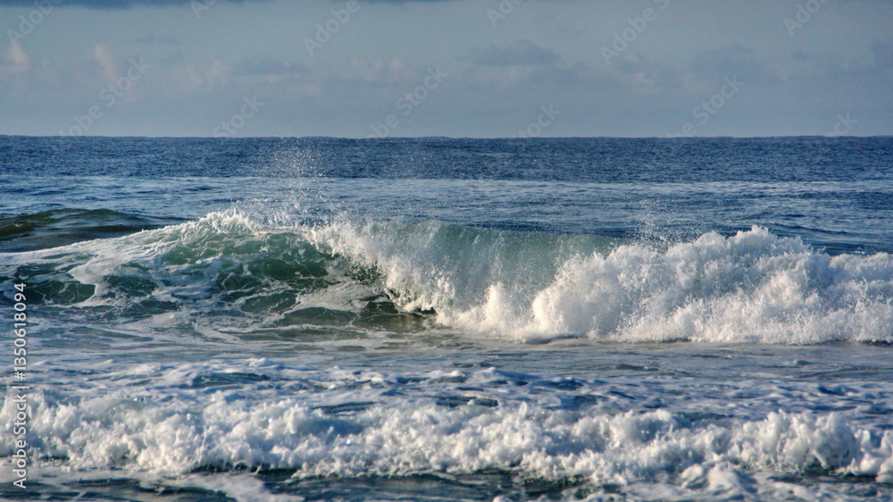 Fototapeta premium Waves breaking just off the beach in Zipolite, Mexico