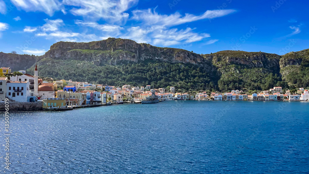 Fototapeta premium Colorful Waterfront Houses On Kastellorizo Island, Greece, Surrounded By Mountains And The Blue Sea, Idyllic Summer Destination, Traditional Architecture, Perfect For Travel, Tourism, And Cultural