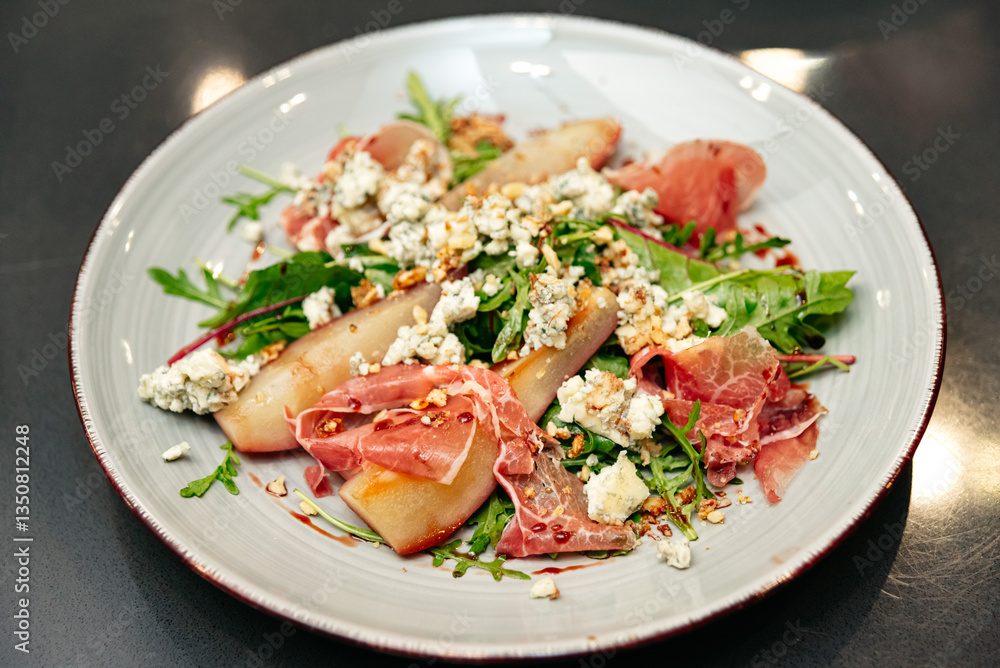 Gourmet salad with poached pears and prosciutto. Gourmet salad with poached pears and prosciutto.